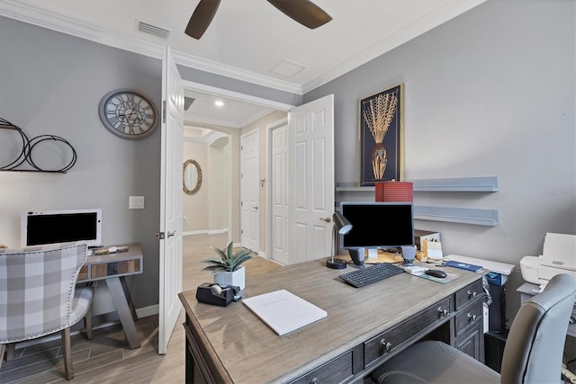 office space with light wood-type flooring, ornamental molding, and ceiling fan