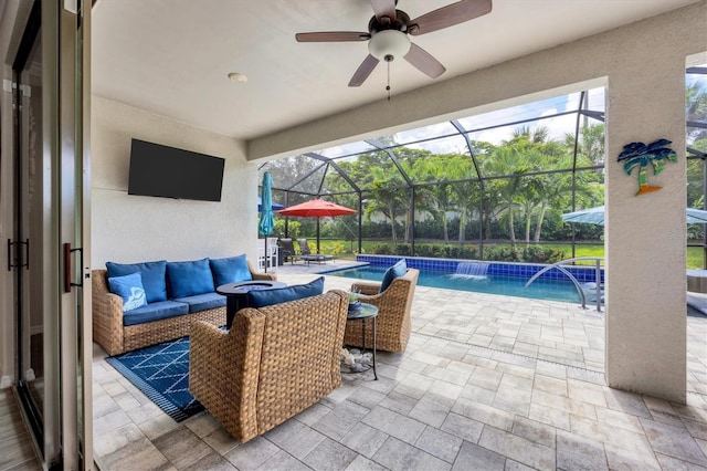 view of patio / terrace with outdoor lounge area, ceiling fan, glass enclosure, and pool water feature