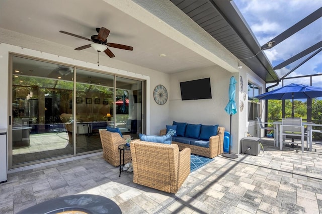 view of patio / terrace with glass enclosure, ceiling fan, and an outdoor hangout area