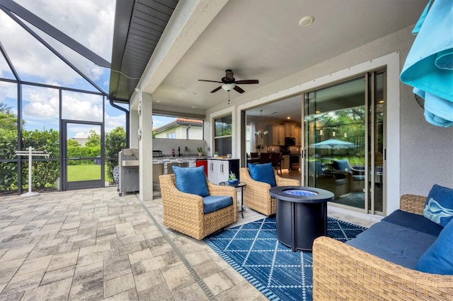 view of patio with ceiling fan, an outdoor kitchen, and a lanai