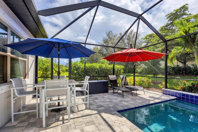 view of swimming pool featuring glass enclosure and a patio area