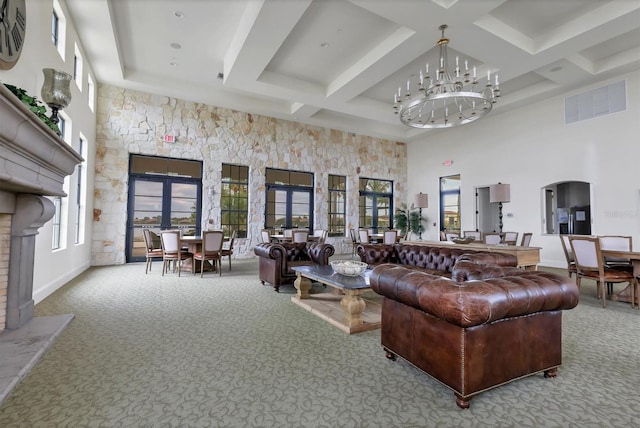 living room with coffered ceiling, a towering ceiling, carpet floors, beam ceiling, and an inviting chandelier