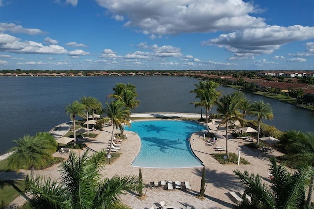 view of swimming pool featuring a patio and a water view