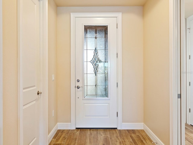 doorway to outside with light hardwood / wood-style floors and a wealth of natural light