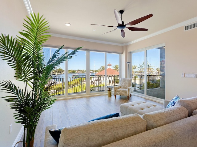 living room with crown molding, hardwood / wood-style floors, and ceiling fan