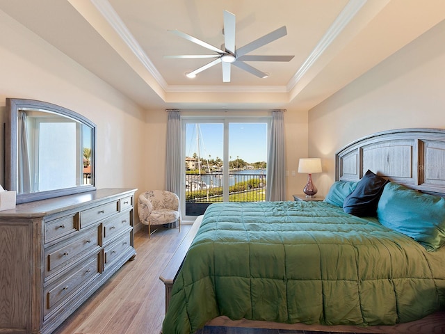 bedroom featuring light hardwood / wood-style floors, a raised ceiling, ceiling fan, access to outside, and ornamental molding