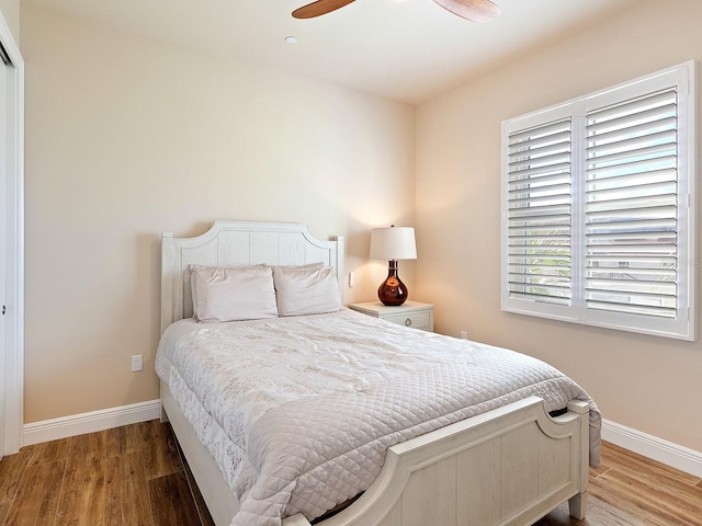 bedroom with wood-type flooring and ceiling fan