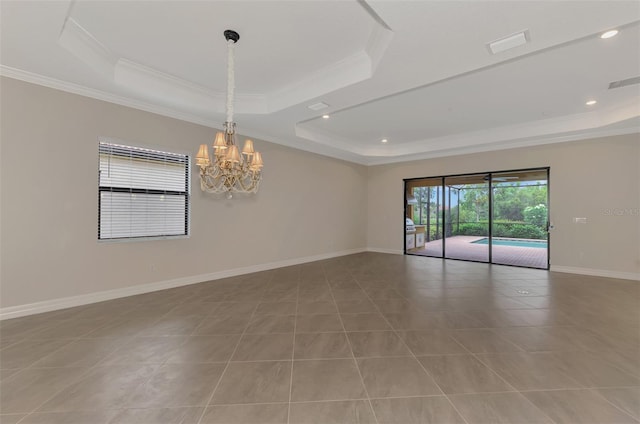 spare room with a raised ceiling, light tile patterned floors, and crown molding