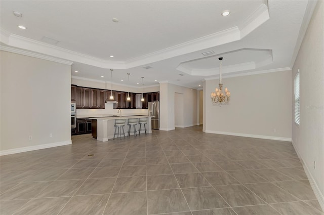 unfurnished living room featuring an inviting chandelier, a raised ceiling, crown molding, and light tile patterned flooring