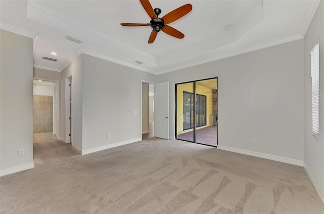 spare room with a tray ceiling, ceiling fan, and crown molding