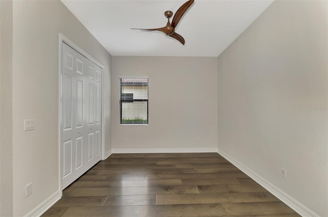 unfurnished bedroom featuring a closet, ceiling fan, and dark hardwood / wood-style floors