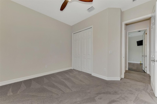 unfurnished bedroom with light carpet, a closet, and ceiling fan