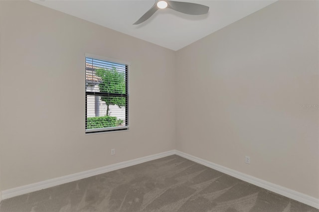 carpeted spare room with ceiling fan