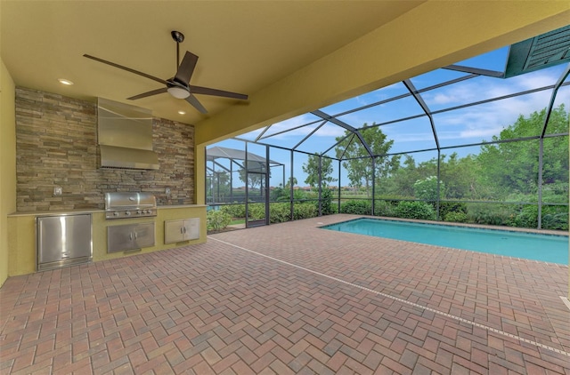 view of swimming pool with a grill, exterior kitchen, a patio, glass enclosure, and ceiling fan