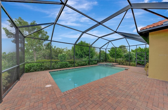 view of swimming pool with glass enclosure, an in ground hot tub, and a patio area