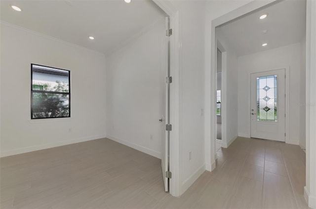 foyer entrance with crown molding and a healthy amount of sunlight