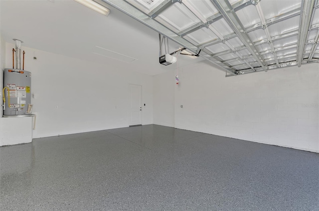 garage featuring water heater and a garage door opener