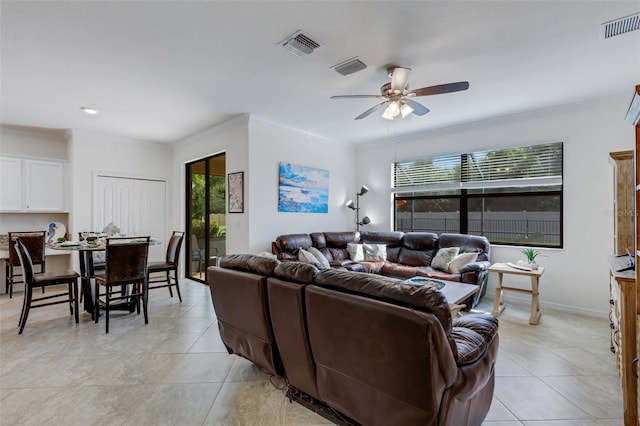 living room with a healthy amount of sunlight, light tile patterned floors, and ceiling fan