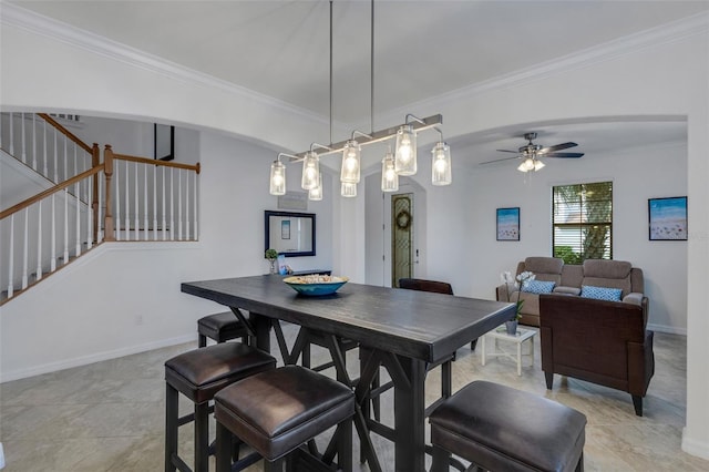 dining area with crown molding, light tile patterned floors, and ceiling fan