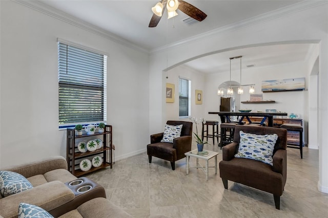 living room with ceiling fan with notable chandelier and ornamental molding