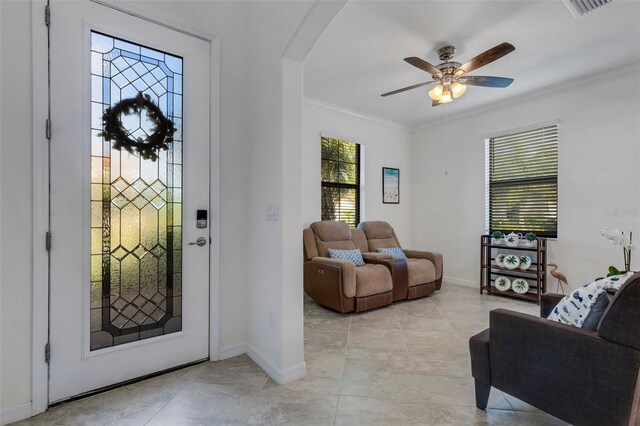 foyer entrance featuring crown molding and ceiling fan