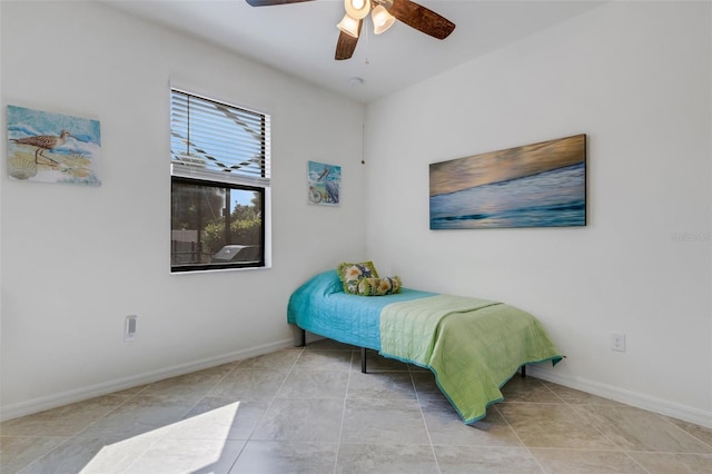 tiled bedroom featuring ceiling fan