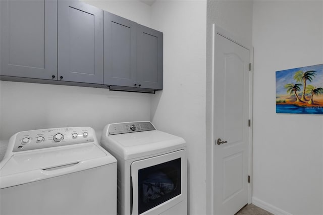 washroom with cabinets and independent washer and dryer