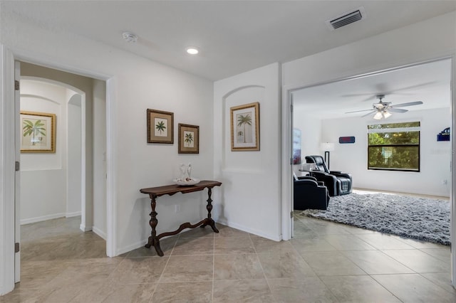 hall with light tile patterned floors