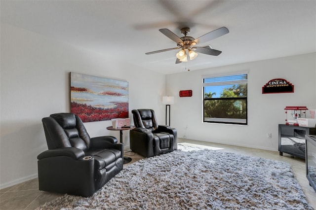 living area with light tile patterned floors and ceiling fan