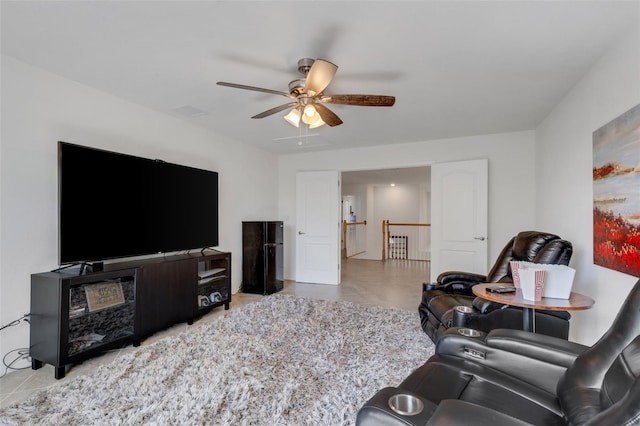 living room featuring ceiling fan and light tile patterned floors