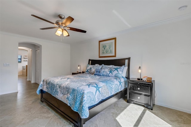 tiled bedroom with ornamental molding and ceiling fan