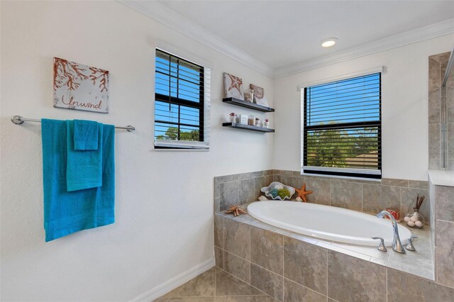 bathroom with tiled tub, ornamental molding, and tile patterned floors