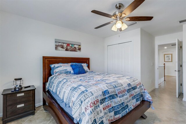 tiled bedroom featuring a closet and ceiling fan