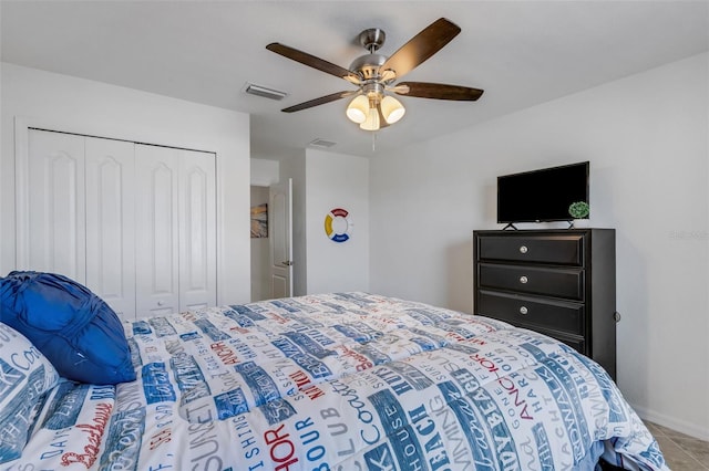 tiled bedroom featuring ceiling fan and a closet