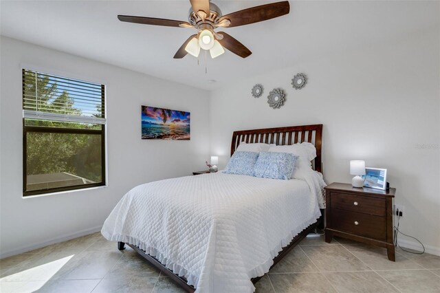 bedroom with light tile patterned flooring and ceiling fan