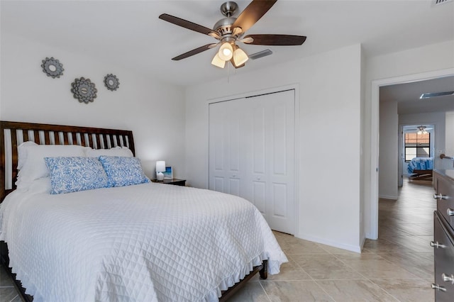 bedroom with a closet, ceiling fan, and light tile patterned floors