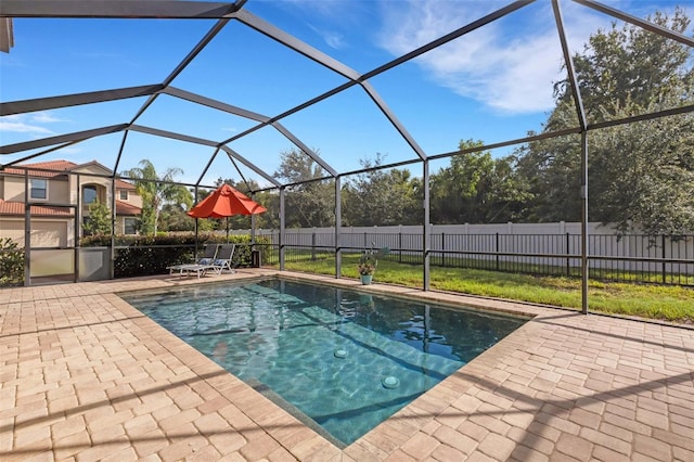 view of swimming pool featuring a patio and glass enclosure