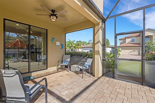 sunroom featuring ceiling fan