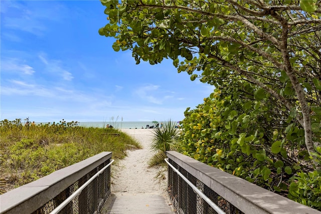 surrounding community featuring a view of the beach and a water view