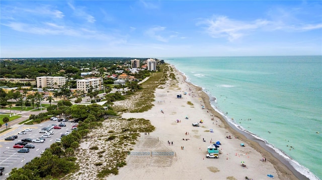 drone / aerial view with a beach view and a water view