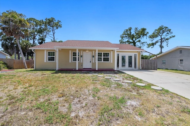 single story home featuring a front lawn and french doors