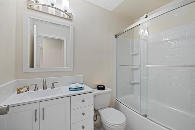 full bathroom featuring enclosed tub / shower combo, vanity, and toilet