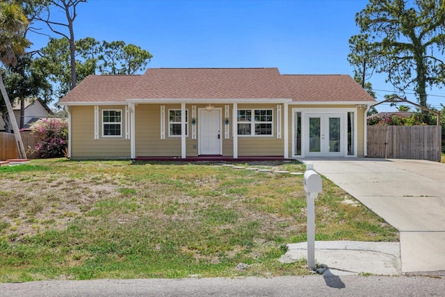 ranch-style home with french doors and a front yard