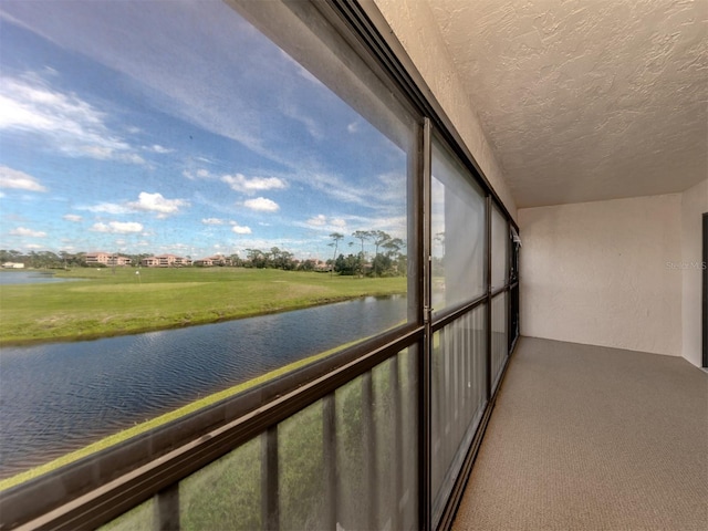 unfurnished sunroom with a water view