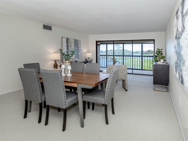 5050 Marianne Key Rd Unit 3B, Punta Gorda, FL 33955 - dining space featuring baseboards, visible vents, and light colored carpet