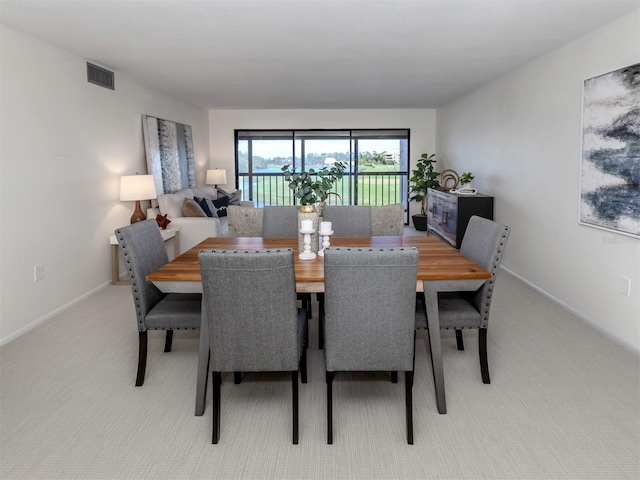 dining area featuring light colored carpet