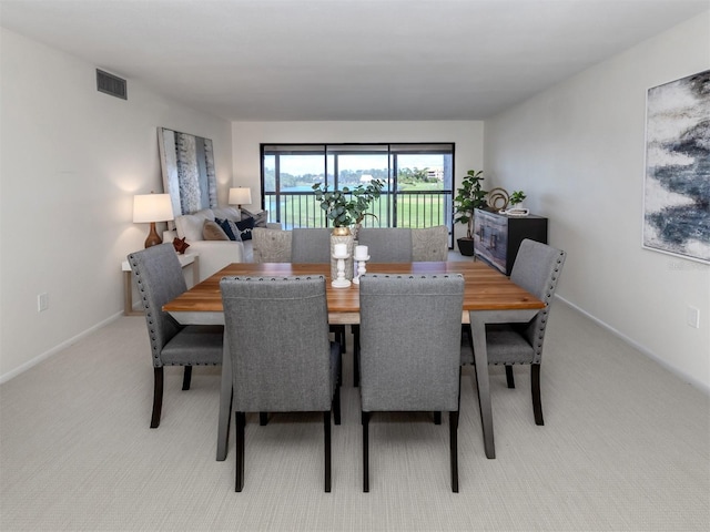 5050 Marianne Key Rd Unit 3B, Punta Gorda, FL 33955 - dining room with baseboards, visible vents, and light colored carpet