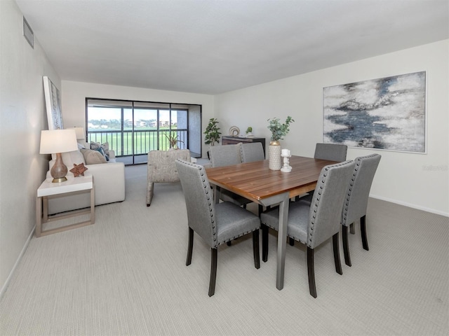 5050 Marianne Key Rd Unit 3B, Punta Gorda, FL 33955 - carpeted dining room with visible vents and baseboards