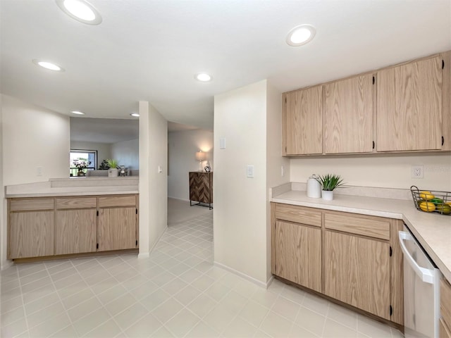 kitchen with light brown cabinets, dishwasher, and light tile patterned floors