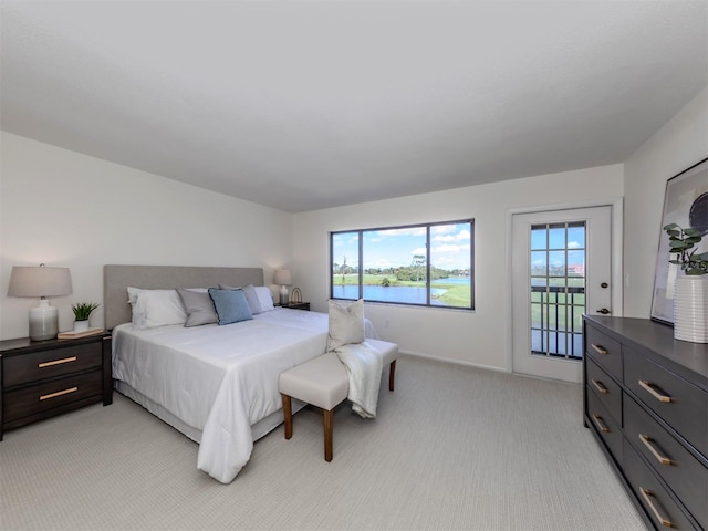 5050 Marianne Key Rd Unit 3B, Punta Gorda, FL 33955 - bedroom featuring multiple windows, access to outside, baseboards, and light carpet